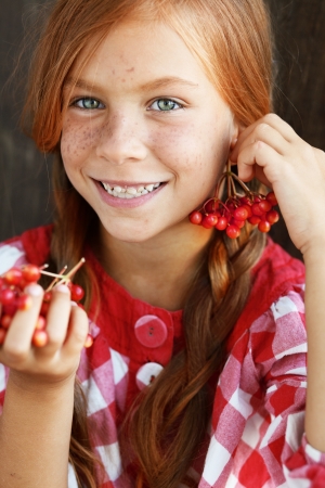 Cute redheaded child on vintage brown backgroundの写真素材
