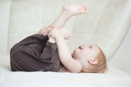 Picture of a baby sitting on a sofa at home