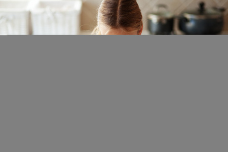 Portrait of a 7 years old girl making salad in kitchen at homeの写真素材