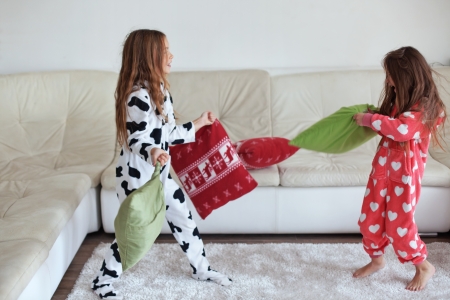 Children in soft warm pajamas playing at homeの写真素材