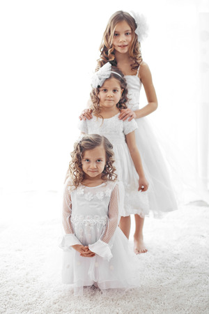 Beautiful little children wearing flower girl dressesの写真素材