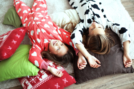 Children in soft warm pajamas playing at home
