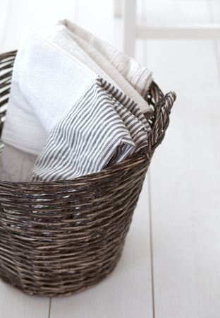 Wicker clothes basket with cotton linen in itの写真素材