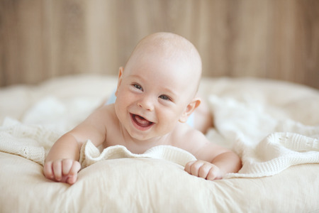 Portrait of a cute 4 months baby lying down on a blanket