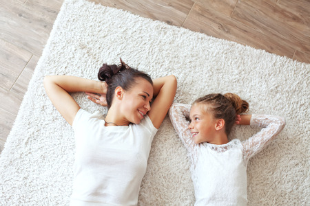 Mother with her preteen daughter at homeの写真素材