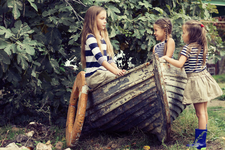 Kids playing inside old boat in summerの写真素材