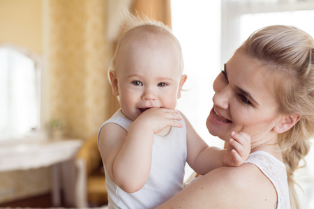 Portrait of a mother with her 1 year old babyの写真素材