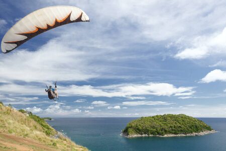 Paraglider flying over beautiful landscape