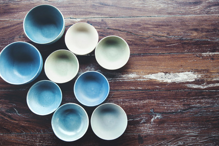 Handmade ceramic dishes on an old vintage table, top view