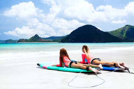 Mom with child are learning surfing togetherの写真素材
