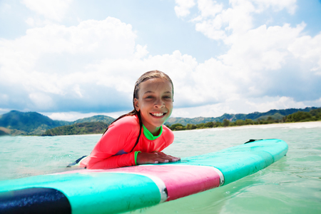 Kid girl is learning surfingの写真素材