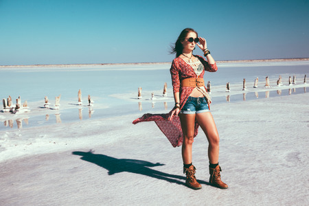 Fashion model wearing bohemian chic clothing posing on the salt beach outdoor.の写真素材