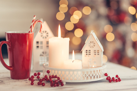 Candles and Christmas decoration on table over blurred evening lights backgroundの写真素材