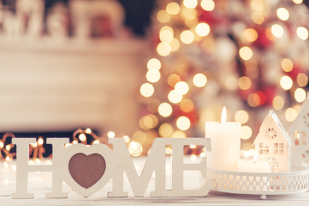 Candles and Christmas decoration on table over blurred evening lights backgroundの写真素材