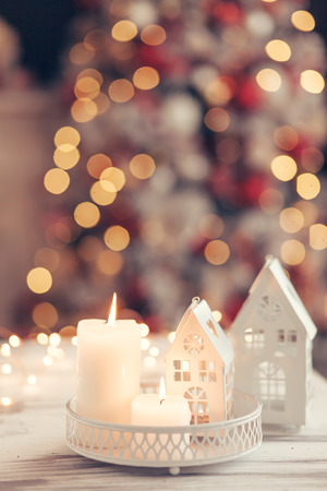 Candles and Christmas decoration on table over blurred evening lights backgroundの写真素材