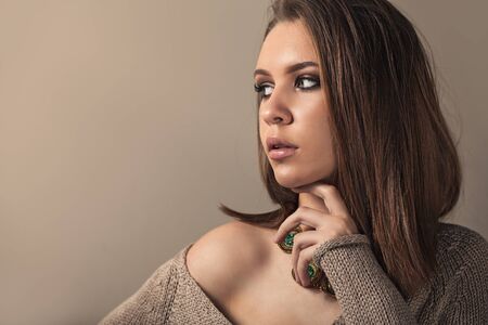 Teen model with perfect smokey makeup on brown background.の写真素材