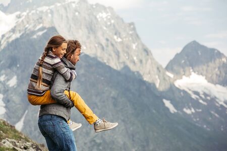 Father with child walking on the mountain and enjoying beautiful view. Family hiking in spring.