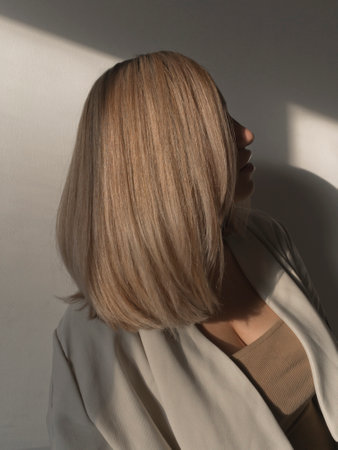 Plus size model with with straight shiny hair after salon care. Woman bob haircut styling.の写真素材
