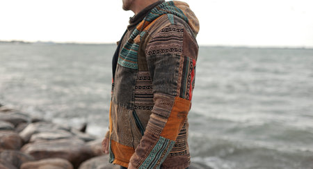 Closeup photo of men boho handmade winter jacket on natural outdoor backroundの写真素材