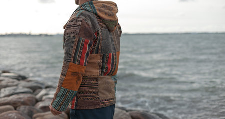 Closeup photo of men boho handmade winter jacket on natural outdoor backroundの写真素材