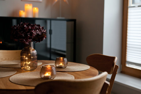 Cozy home atmosphere. Led lights and interior decor on wooden table in scandinavian room. Hygge life...