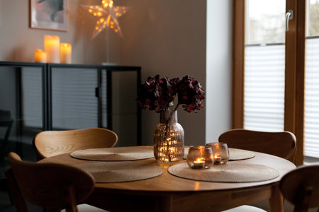 Cozy home atmosphere. Led lights and interior decor on wooden table in scandinavian room. Hygge life...