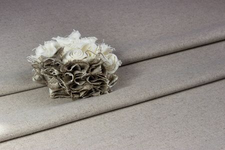 Beautiful rose flower made of fabric on linen, backgroundの写真素材