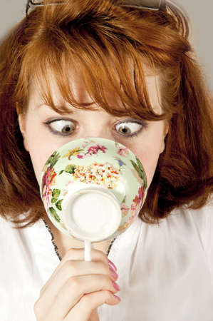 Youn woman with cup of teaの写真素材