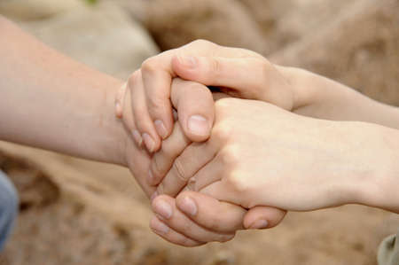 Man's and female hands are fastened together.Taken as closeup.の写真素材