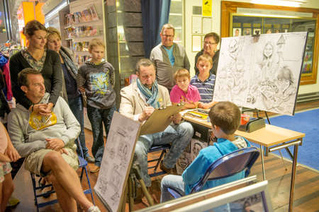 The artist draws a portrait of the child. Taken in Finland on September 2012のeditorial素材
