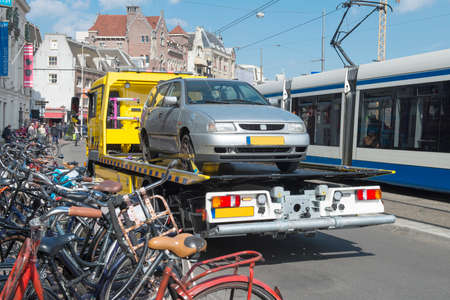 Amsterdam, The Netherlands - April 05, 2014; Tow Truck urban towing away a wrongly parked car in Amsterdam.のeditorial素材