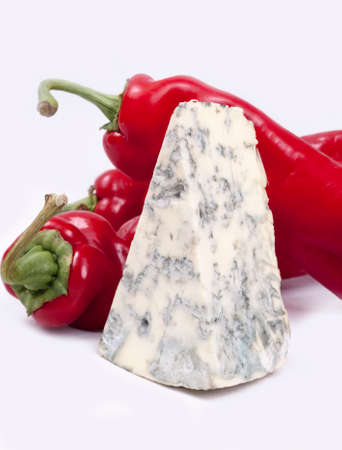 Mold cheese and red pepper on the white bacground.の写真素材