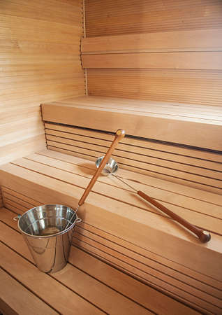 Bucket and scoop in wooden finnish sauna background.の写真素材