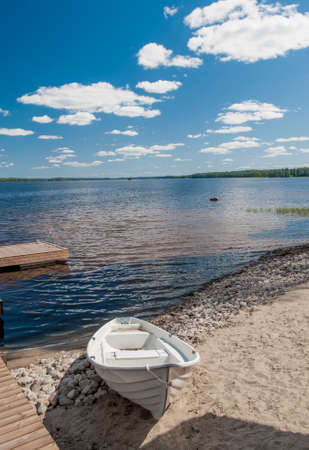 Wooden white boan on the lake in Finlandwhite, white boat,の写真素材