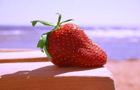 Strawberry fresh. Lay on the sand. Outdoors. Conceptual design ideas for wedding cards.の写真素材