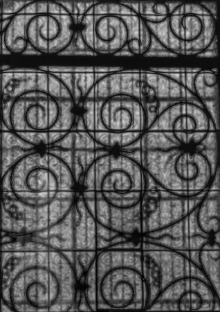 Picture of a twisted metal window grille through a patterned glass