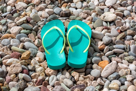 Flip-flops on the colored pebble beach. Summer and vacation conceptの写真素材