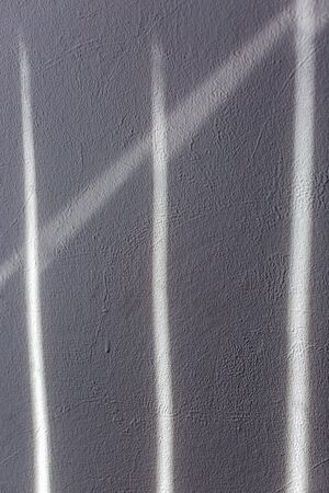 Sunbeam on painted wallpaper wall. Abstract black and white texture backgroundの写真素材