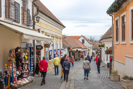 Szentendre, Hungary - March 10, 2019: Tourists walk along cozy street with souvenir shopsのeditorial素材