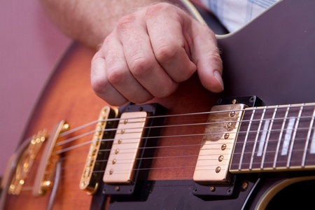 Man s hand, playing the guitar