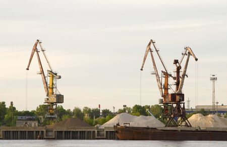 View of harbor cranes from a boat, floating on the river Volgaのeditorial素材