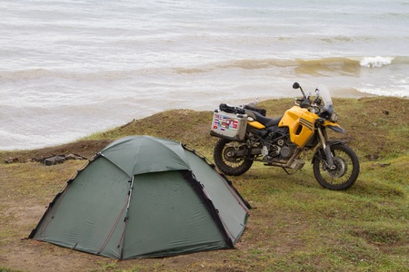 Tent and motorcycle traveler on the shores of Lake Baikalの写真素材