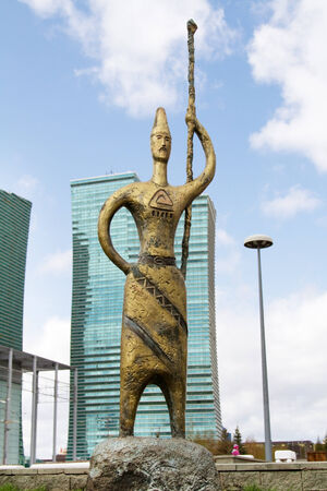 Bronze sculpture on glass background of the business center in Astanaの写真素材