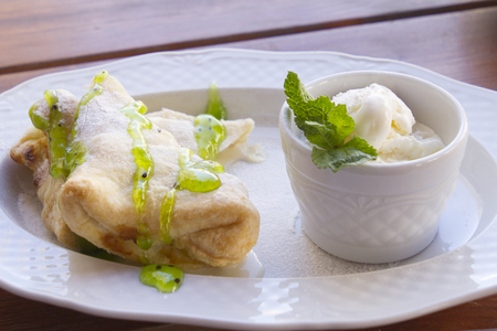 Strudel with pear and bowl with ice creamの写真素材