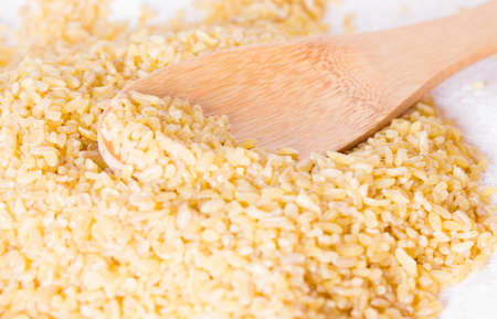 Bulgur in a wooden spoonの写真素材