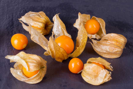 Berries Physalis on black stone backgroundの写真素材