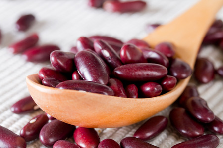 Red beans in a wooden spoon