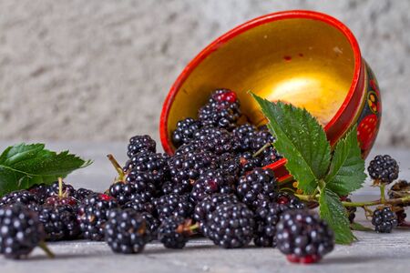 Blackberries on the old wooden table in traditional Russian dishesのeditorial素材