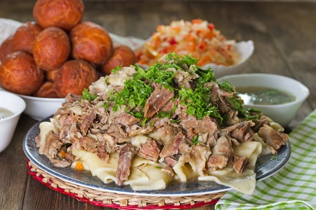 National Kazakh dishes - Beshbarmak, salad of radish Shalgam, and for dessert Baursak.