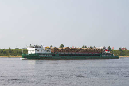 KIROVSK, RUSSIA - JUNE 24: The barge carries timber along the Neva River on June 24, 2016 in Kirovsk.のeditorial素材